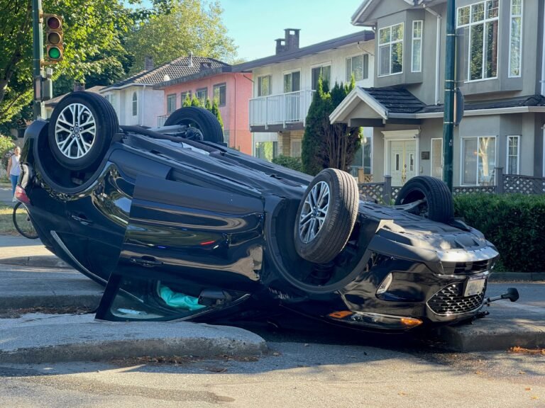 Overturned vehicle showing severe car accident damage and rollover impact in residential neighborhood