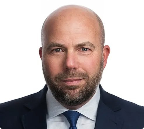 About Us Headshot of David Reservitz in a suit and tie against a white background